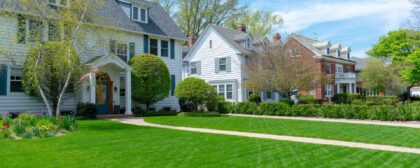 Row of traditional suburban homes and front lawns in a nice neighbourhood.