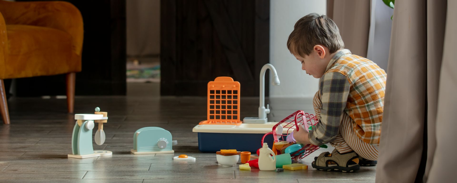 Little boy playing with toys at home.