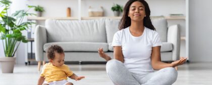 Mom and child meditating.