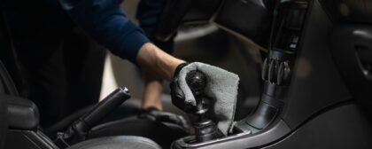 Cleaning a car interior in the studio - wiping down the gear stick