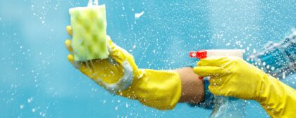 Close-up of a person wearing gloves, cleaning their windows