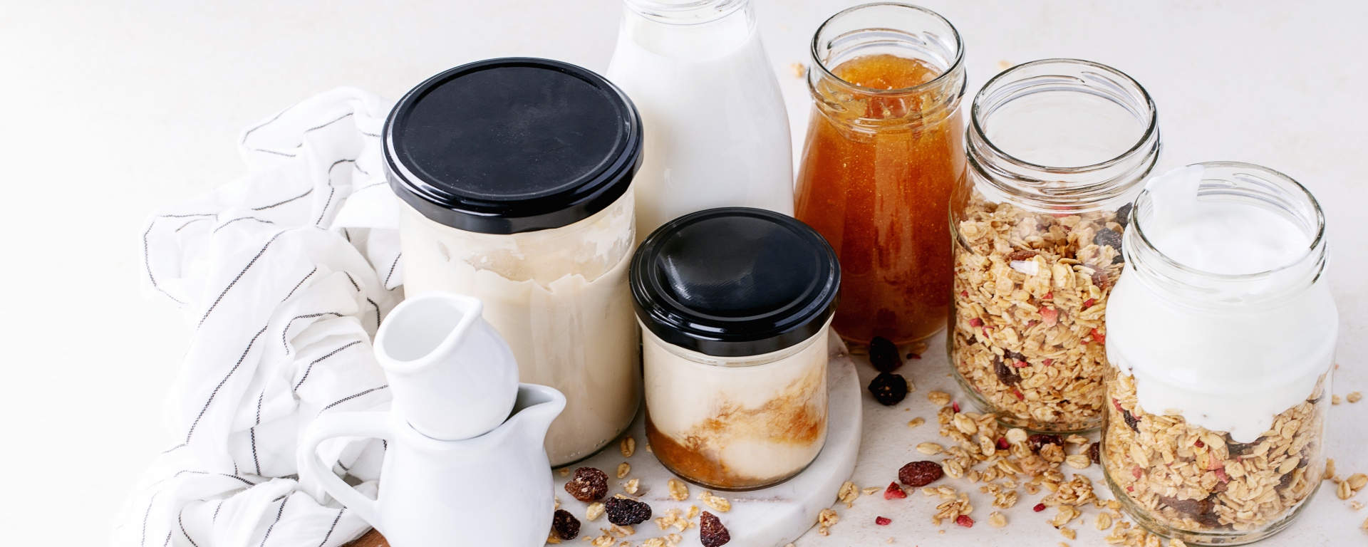 Assortment of glass jars with muesli and other breakfast