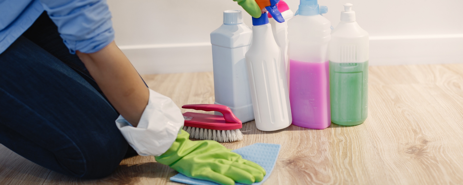 Close-up shot of a housewife working at home with a set of cleaning supplies.